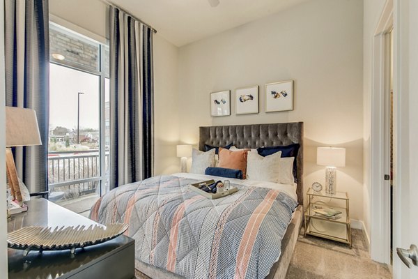 Cozy bedroom with river views at Eastbank Riverwalk Apartments, luxury living near downtown, ideal for comfort and relaxation