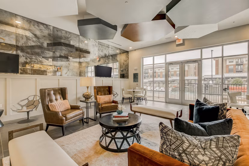 Modern clubhouse with spacious seating at Eastbank Riverwalk Apartments, offering luxury amenities and social spaces for residents