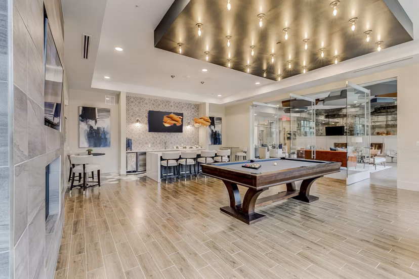 Game room with pool table and lounge seating at Eastbank Riverwalk Apartments, ideal for relaxation and entertainment