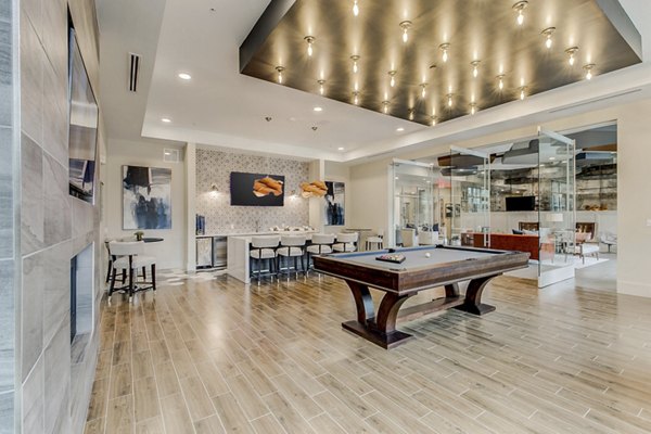 Game room with pool table and lounge seating at Eastbank Riverwalk Apartments, ideal for relaxation and entertainment
