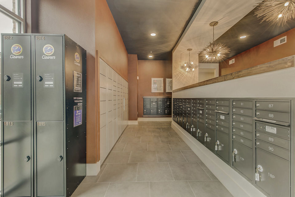 Modern mail room with secure package lockers at Eastbank Riverwalk Apartments