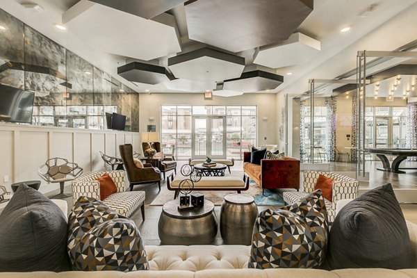 Clubhouse with modern seating and large windows at Eastbank Riverwalk Apartments, offering a stylish space for socializing and relaxing