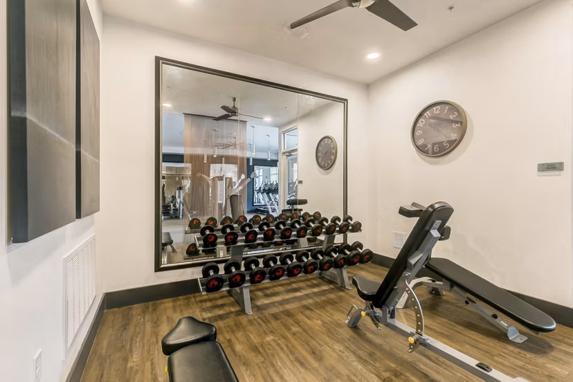 State-of-the-art fitness center at Eastbank Riverwalk Apartments offering modern exercise equipment and spacious workout areas
