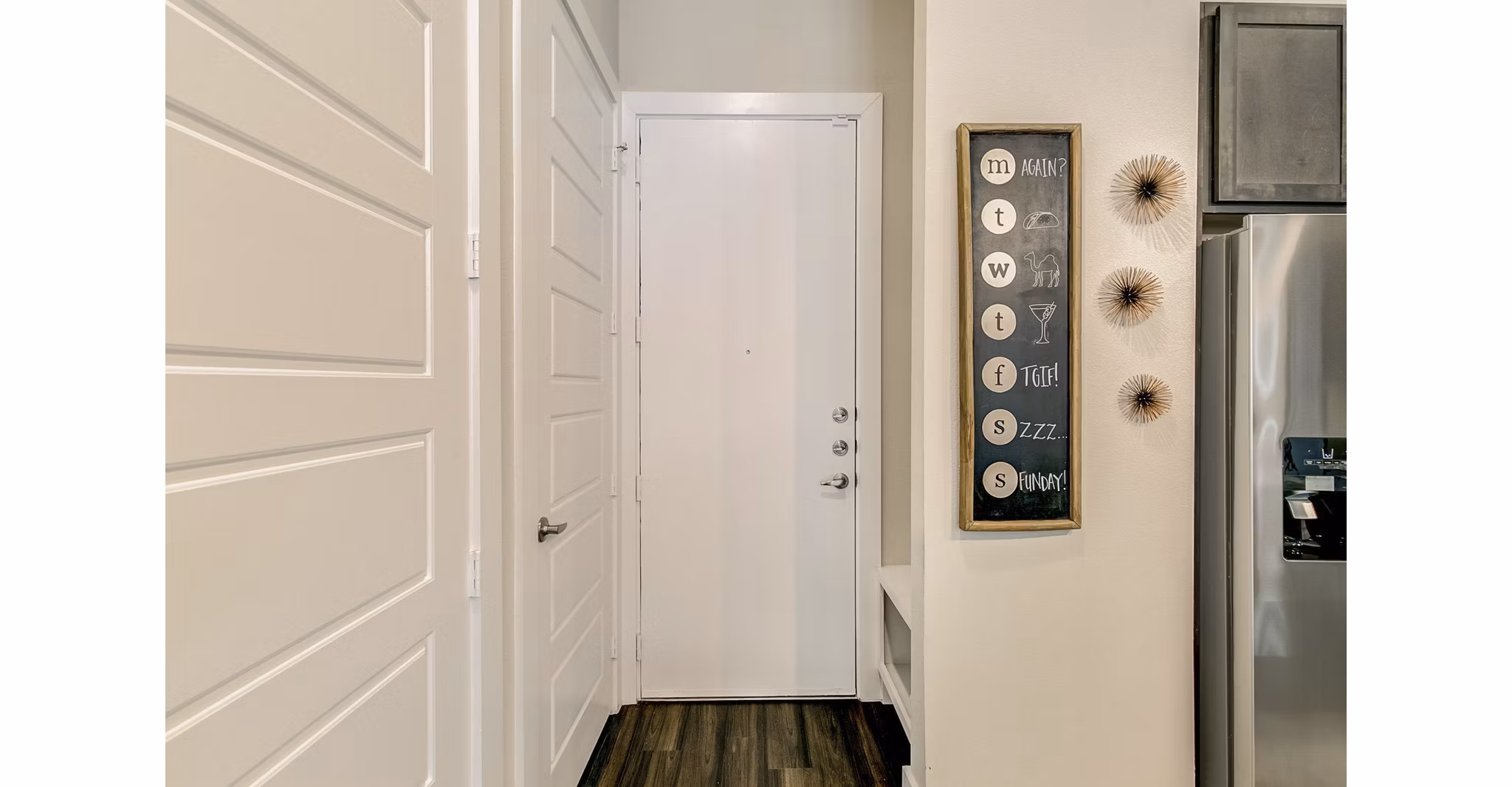 Hallway with modern lighting and sleek flooring in Eastbank Riverwalk Apartments