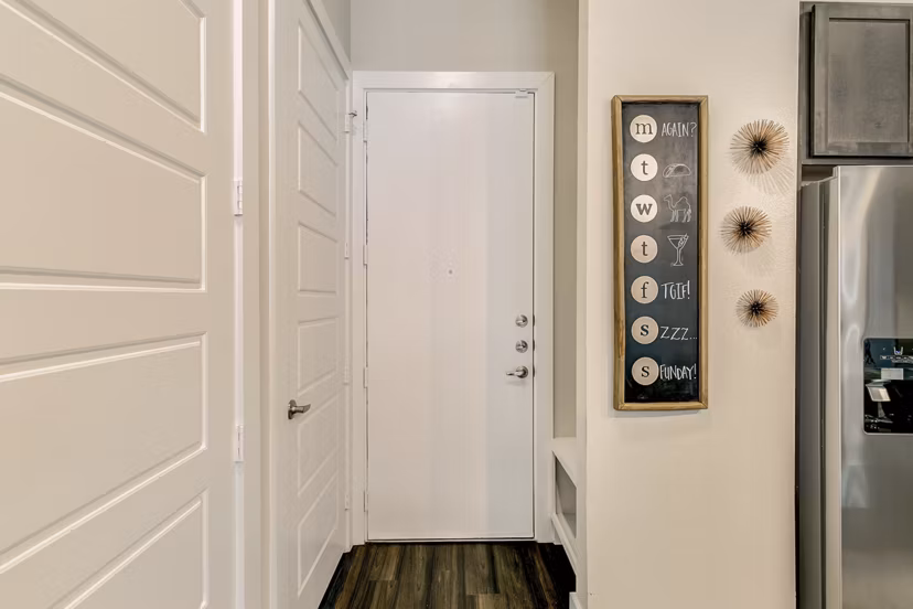 Hallway with modern lighting and sleek flooring in Eastbank Riverwalk Apartments