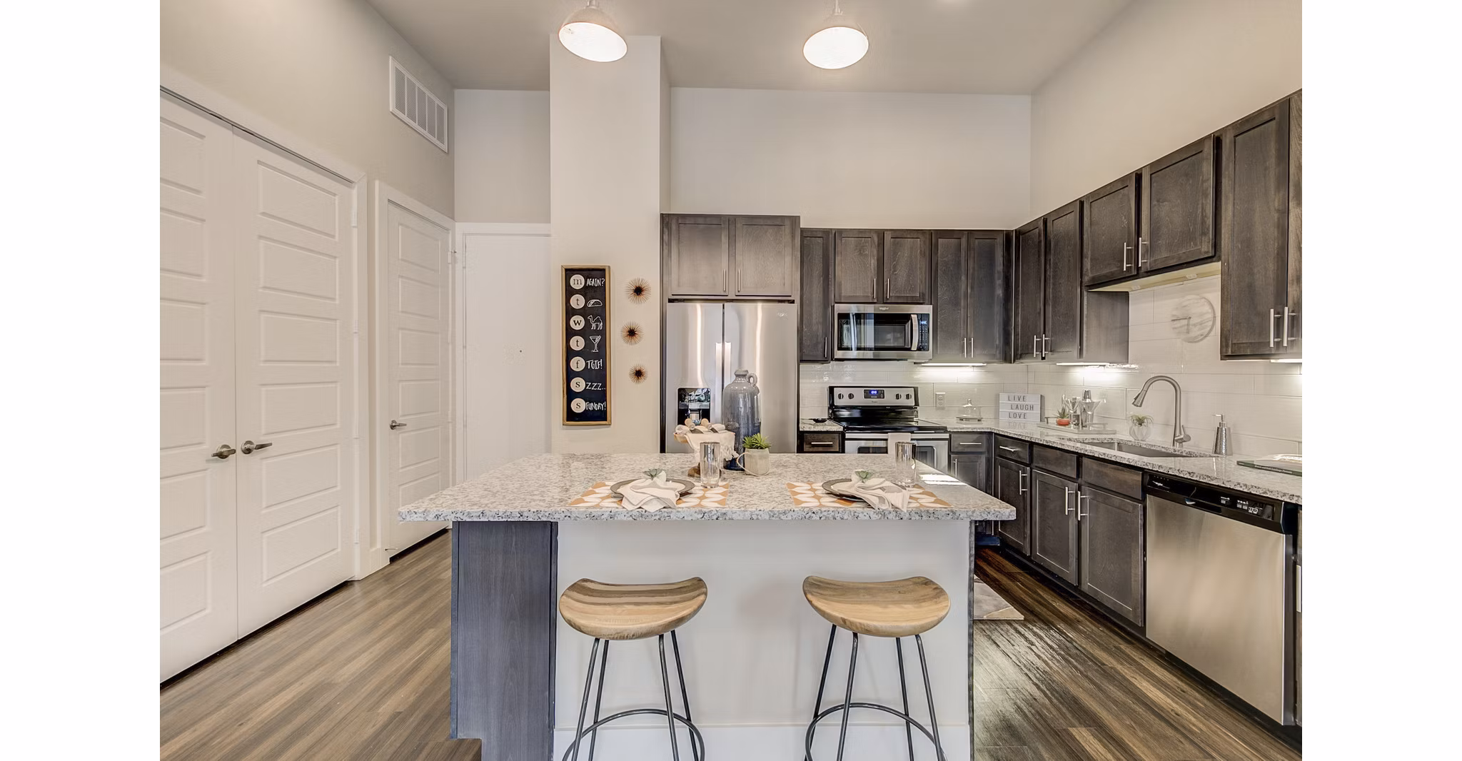 Modern kitchen with stainless steel appliances and granite countertops at Eastbank Riverwalk Apartments
