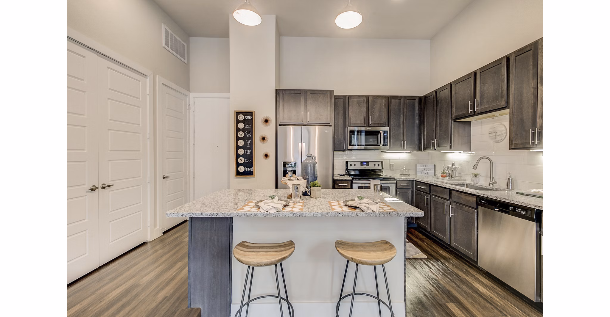 Modern kitchen with stainless steel appliances and granite countertops at Eastbank Riverwalk Apartments