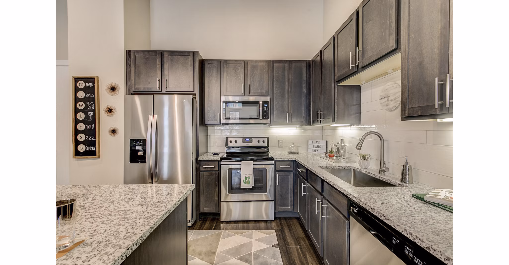 Contemporary kitchen design with stainless steel appliances at Eastbank Riverwalk Apartments