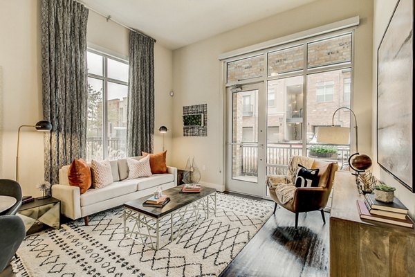 Spacious living room with modern furnishings at Eastbank Riverwalk Apartments, luxurious Greystar property