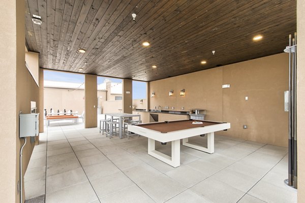 Courtyard with lush greenery at Eastbank Riverwalk Apartments, offering a serene outdoor space for residents to relax and socialize