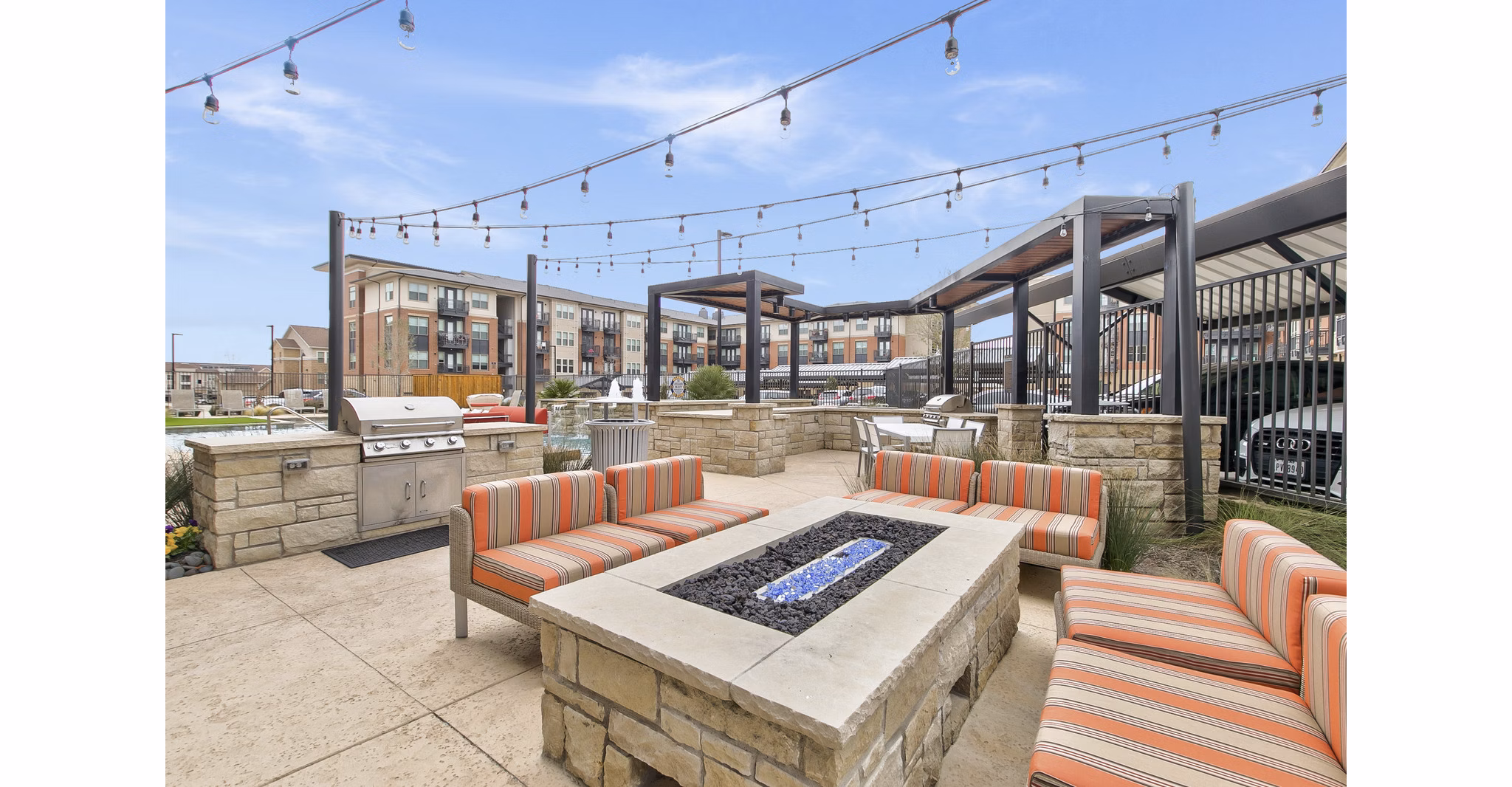 Cozy fire pit lounge area at Eastbank Riverwalk Apartments near scenic river views for luxury relaxation outdoors