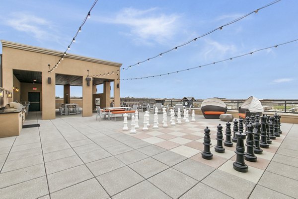 Outdoor sport court at Eastbank Riverwalk Apartments featuring basketball hoops and tennis nets, ideal for active residents seeking recreational activities