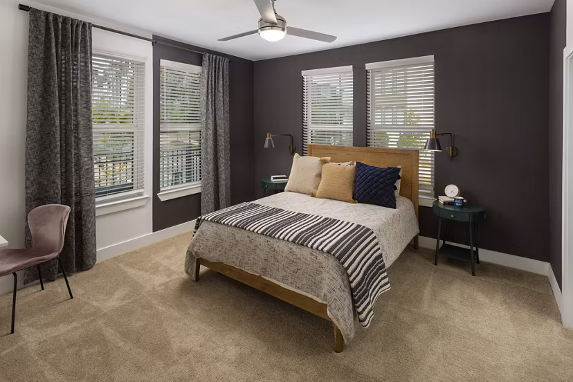 Bedroom featuring modern decor and large windows at Elan Madison Yards Apartments