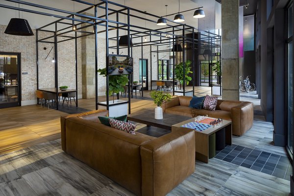 Clubhouse featuring modern design and comfortable seating at Elan Madison Yards Apartments, perfect for social gatherings and relaxation