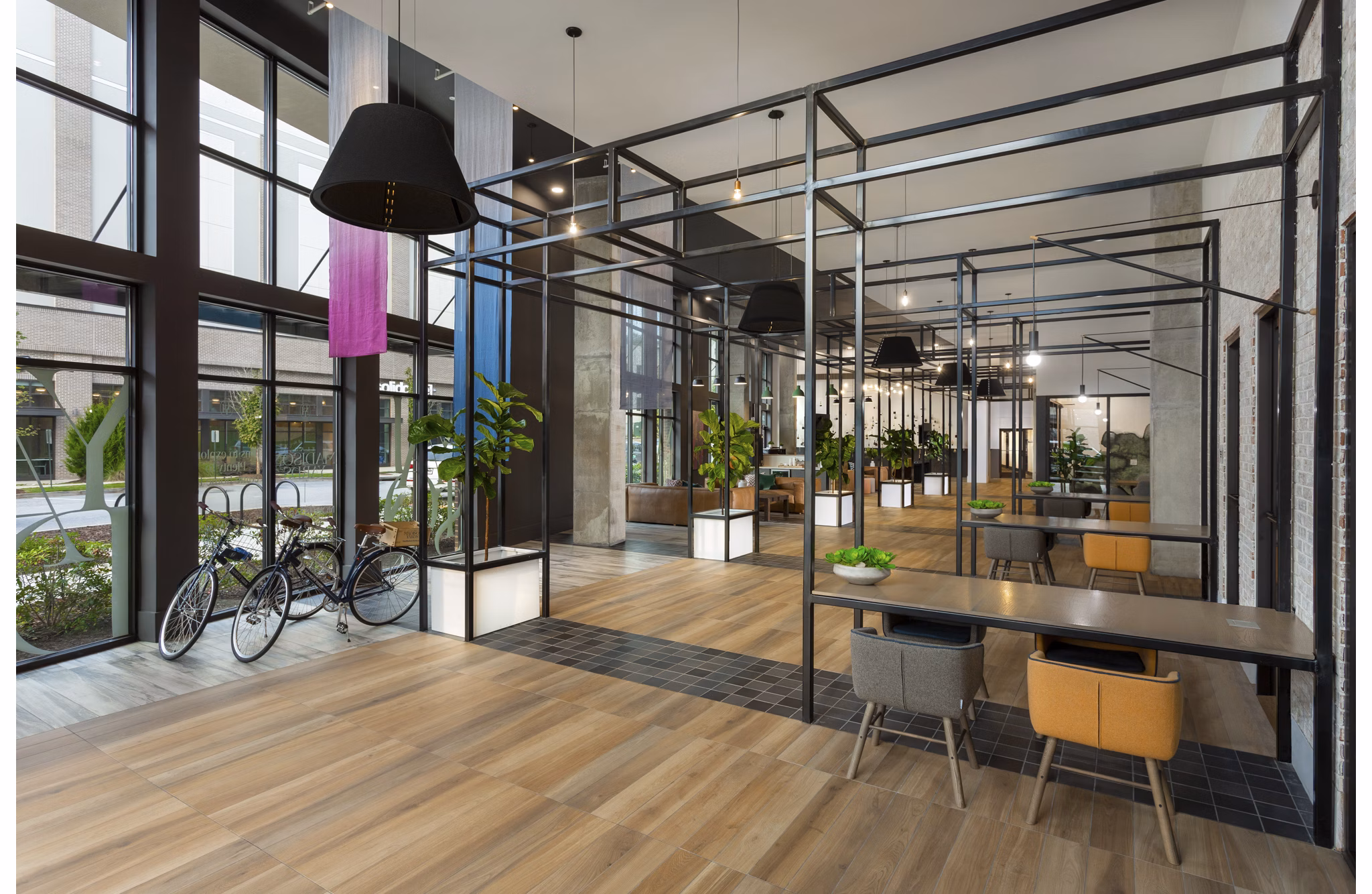 Clubhouse with modern design and ample seating at Elan Madison Yards Apartments