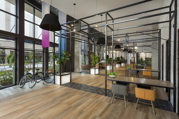 Clubhouse with modern design and ample seating at Elan Madison Yards Apartments