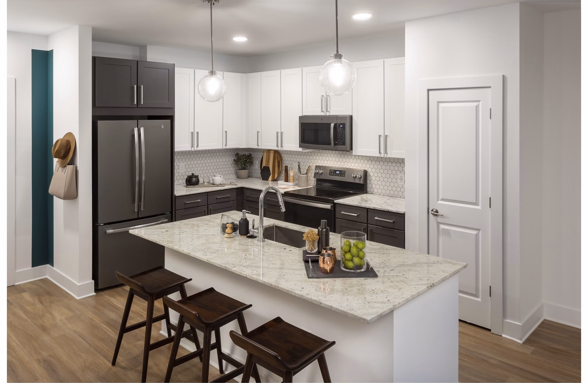 Modern kitchen with sleek countertops and stainless appliances in Elan Madison Yards Apartments, a luxury living space