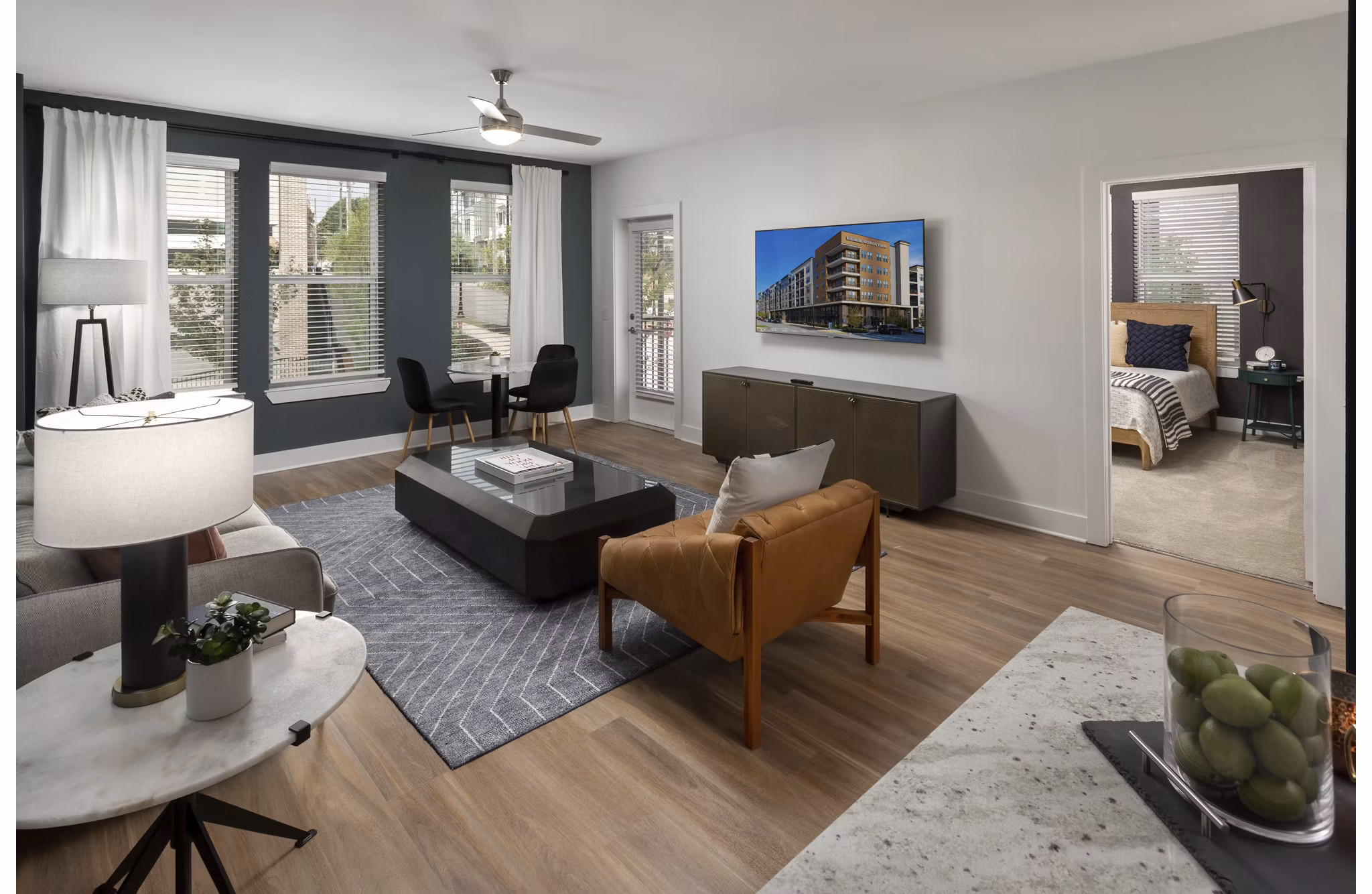 Living room with contemporary decor and natural light in Elan Madison Yards Apartments