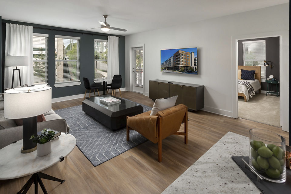 Living room with contemporary decor and natural light in Elan Madison Yards Apartments