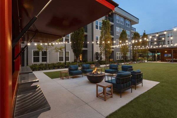 Cozy outdoor fire pit at Elan Madison Yards Apartments, perfect for social gatherings and relaxation in an inviting community space