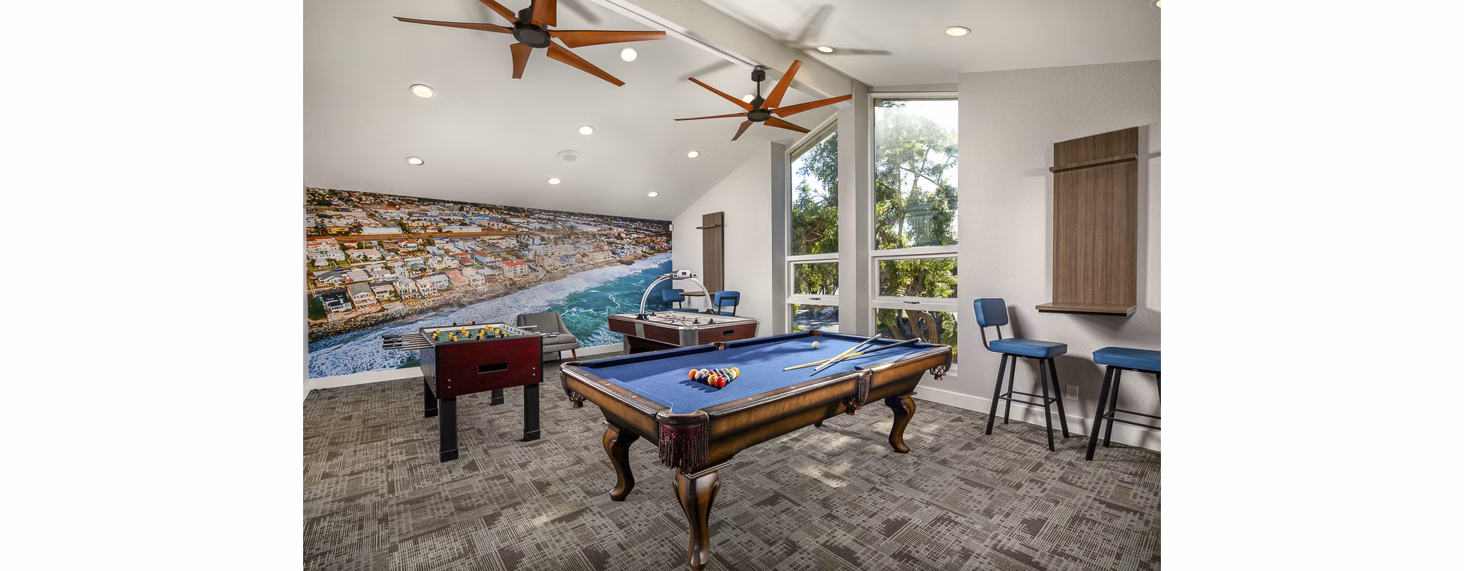 Game room featuring pool table and lounge seating at Presidio at Rancho Del Oro Apartments