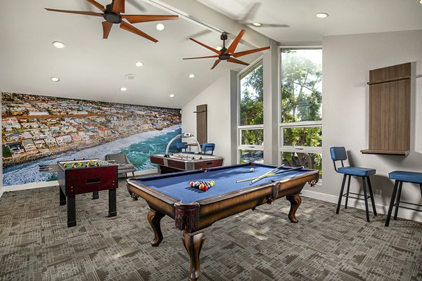 Game room featuring pool table and lounge seating at Presidio at Rancho Del Oro Apartments