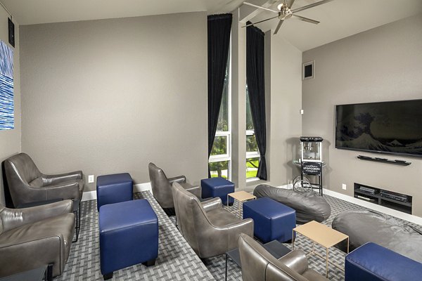 Theater with plush seating and large screen at Presidio at Rancho Del Oro Apartments, luxury living by Greystar