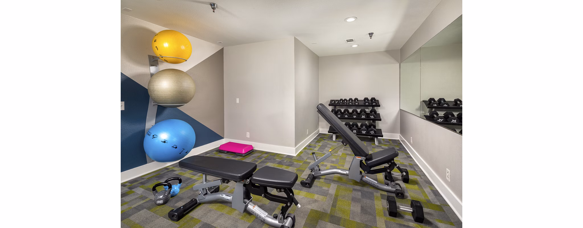 Modern fitness center equipped with cardio and strength machines at Presidio at Rancho Del Oro Apartments