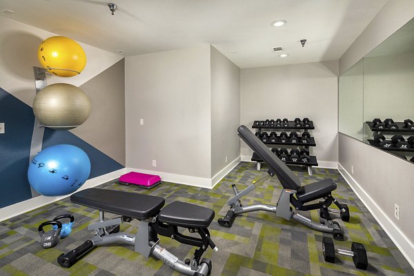 Modern fitness center equipped with cardio and strength machines at Presidio at Rancho Del Oro Apartments