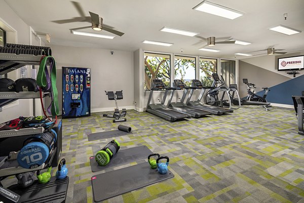 State-of-the-art fitness center at Presidio at Rancho Del Oro Apartments featuring modern equipment