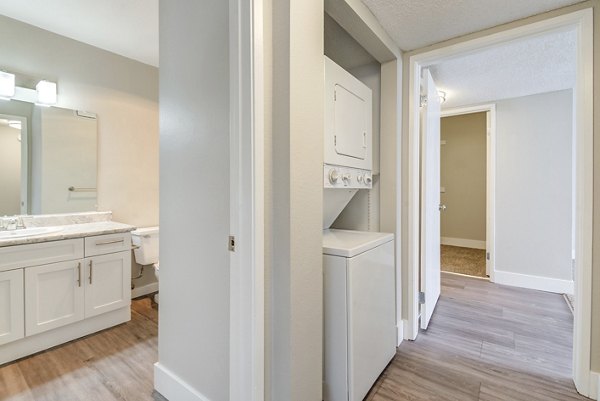 Bright hallway with modern lighting and artwork at Presidio at Rancho Del Oro Apartments