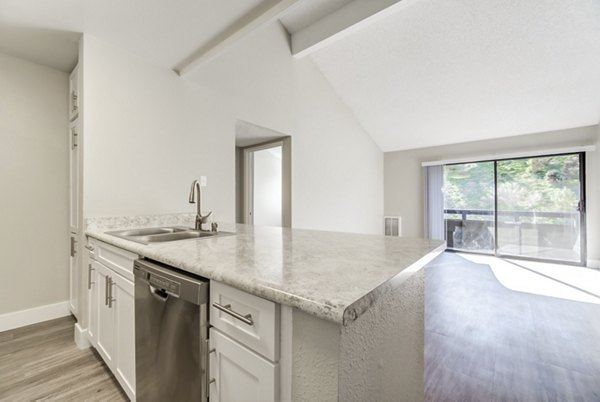 Modern kitchen featuring stainless steel appliances at Presidio at Rancho Del Oro Apartments