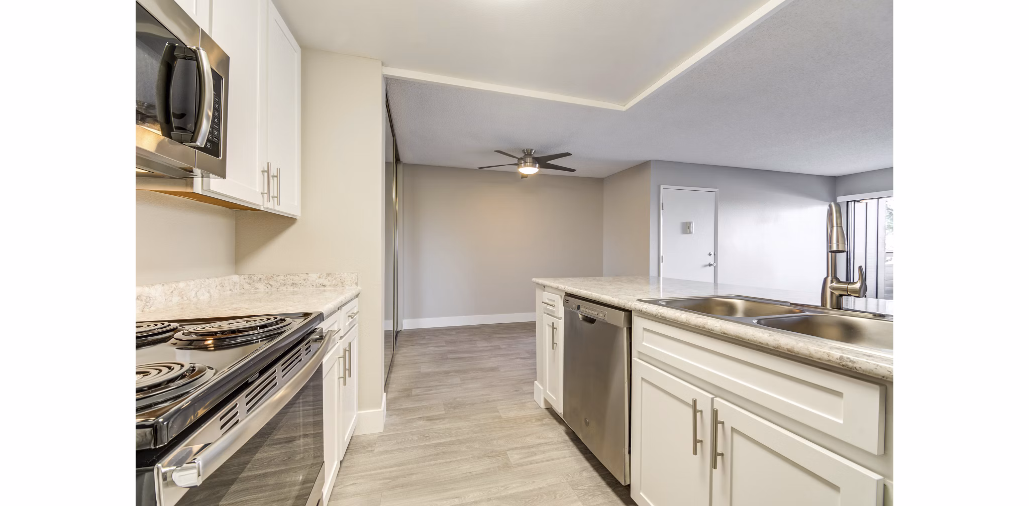 Modern kitchen with stainless steel appliances at Presidio at Rancho Del Oro Apartments