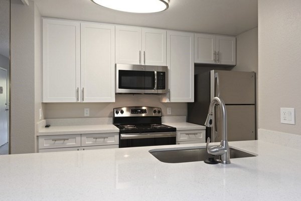 Modern kitchen with stainless steel appliances at Presidio at Rancho Del Oro Apartments