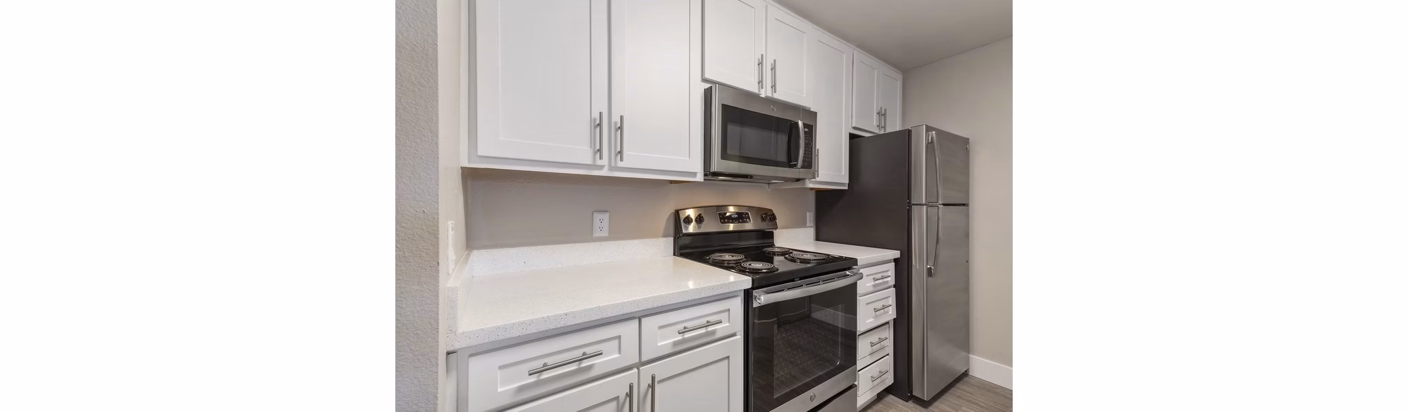 Modern kitchen featuring stainless steel appliances at Presidio at Rancho Del Oro Apartments
