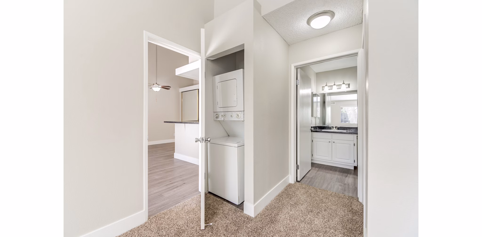 Laundry room featuring modern appliances at Presidio at Rancho Del Oro Apartments