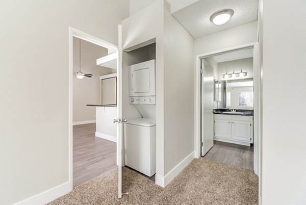 Laundry room featuring modern appliances at Presidio at Rancho Del Oro Apartments