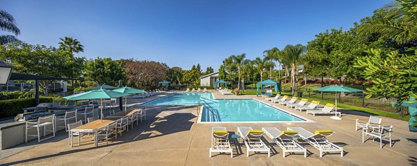 Outdoor pool with lounge seating at Presidio at Rancho Del Oro Apartments