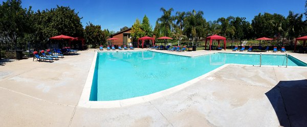 Relaxing pool with lounge chairs at Presidio at Rancho Del Oro Apartments