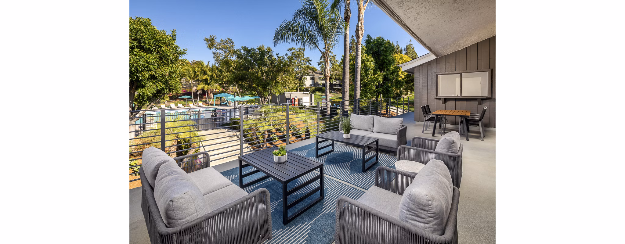 Spacious rooftop deck with lounge seating at Presidio at Rancho Del Oro Apartments offering panoramic views and relaxation space