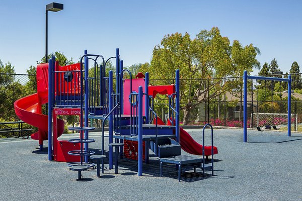 Playground area with slides and swings at Presidio at Rancho Del Oro Apartments, a family-friendly amenity for residents