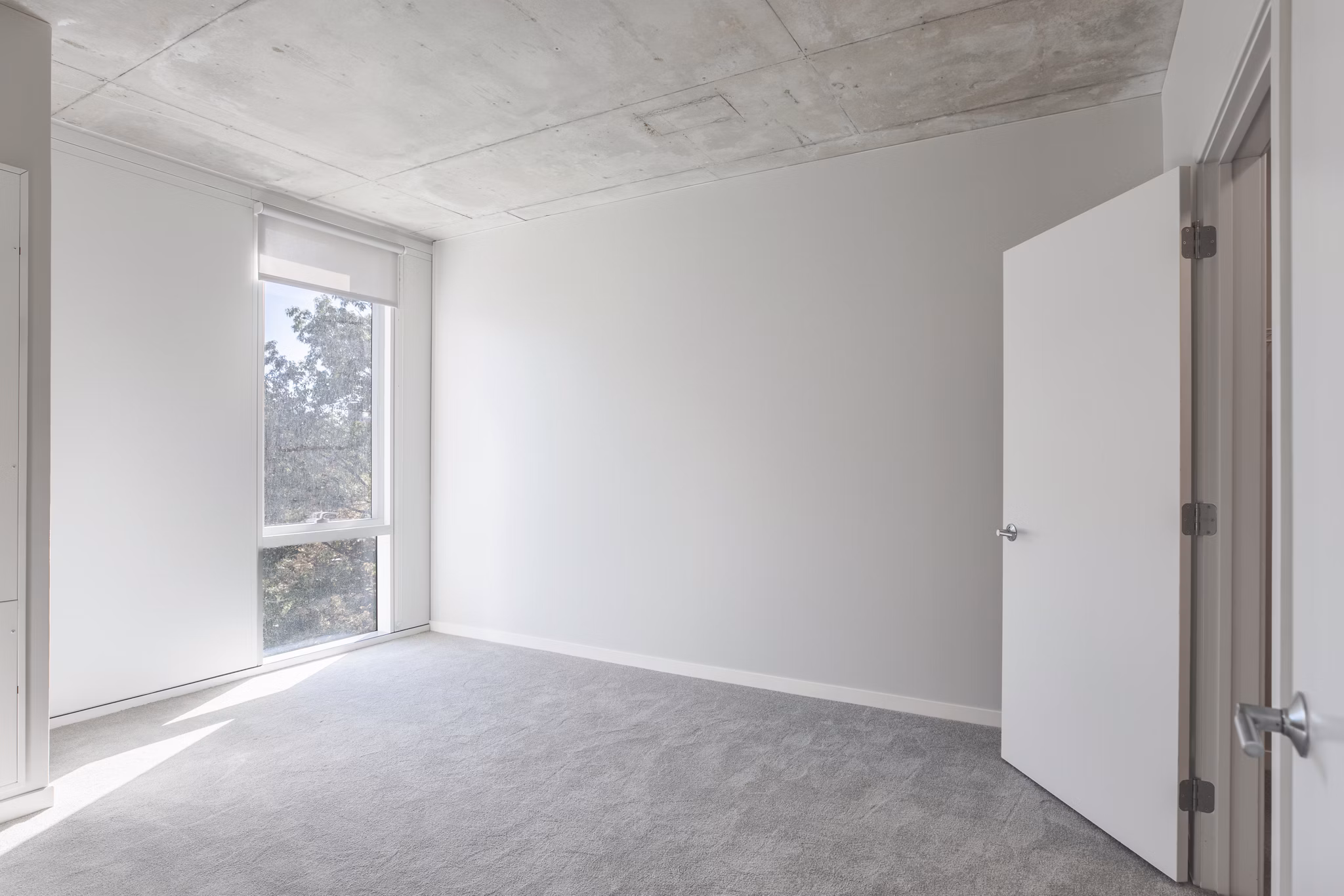 Modern bedroom with cozy ambiance and elegant decor in The Chestnut Apartments, a luxury Greystar property