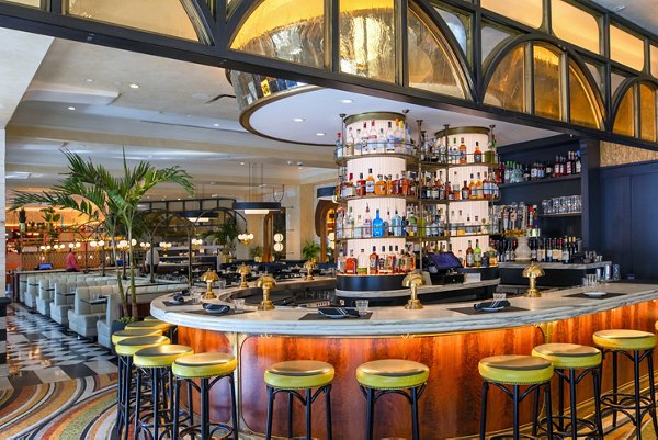Modern bar area with circular counter and stylish seating at luxury apartments