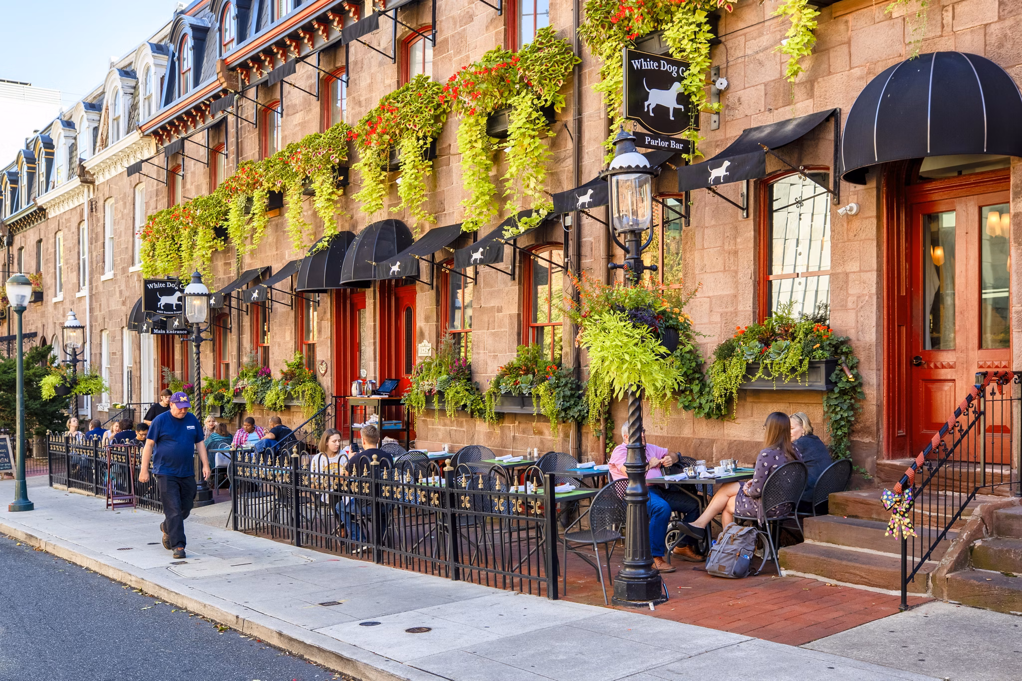 Charming street scene with outdoor dining and vibrant red doors at luxury apartments