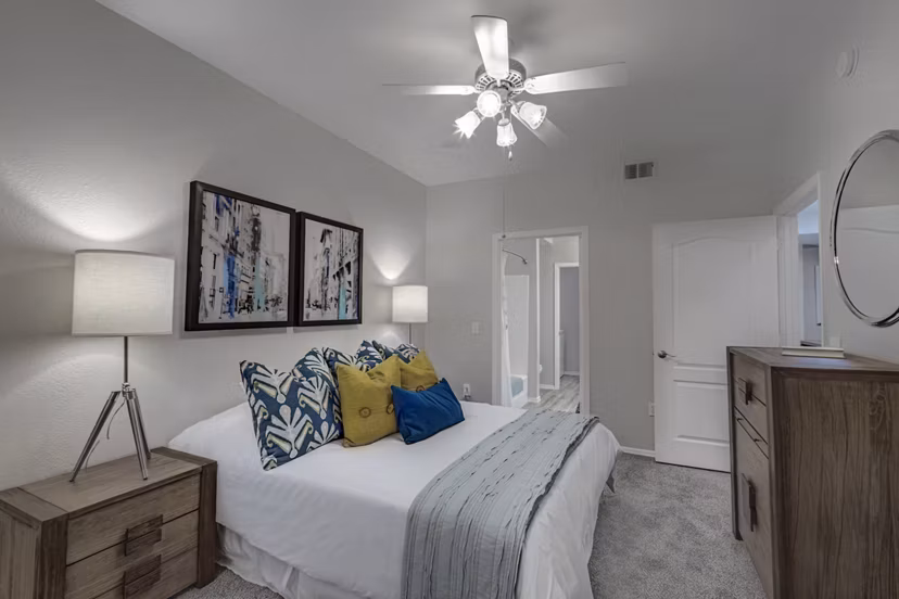 Cozy bedroom with large windows at Springs at Continental Ranch Apartments