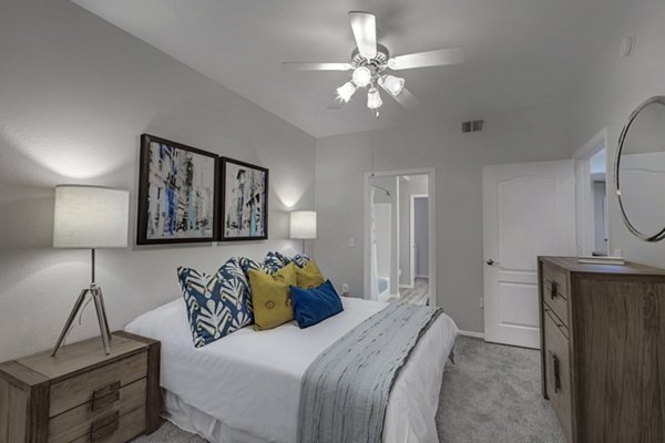 Cozy bedroom with large windows at Springs at Continental Ranch Apartments