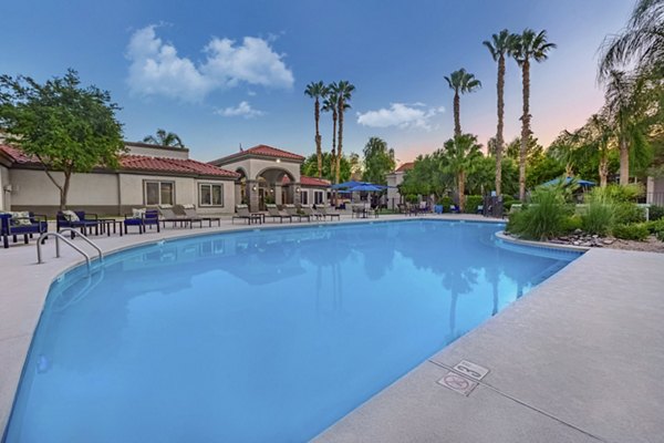 Outdoor pool with loungers at Springs at Continental Ranch Apartments