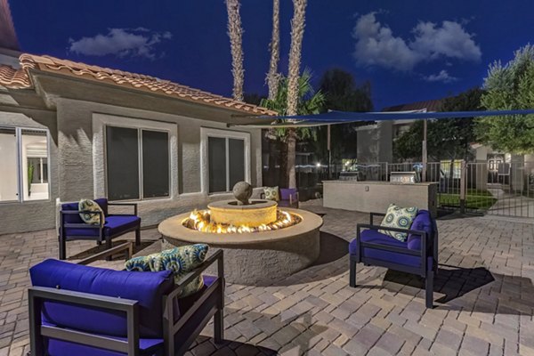 Fire pit area with cozy seating at Springs at Continental Ranch Apartments Perfect for social gatherings or relaxing evenings outdoors