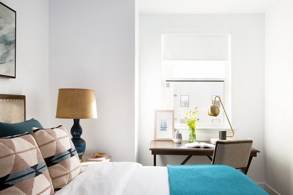 Spacious bedroom with modern decor at The Madelon Apartments, luxury living by Greystar