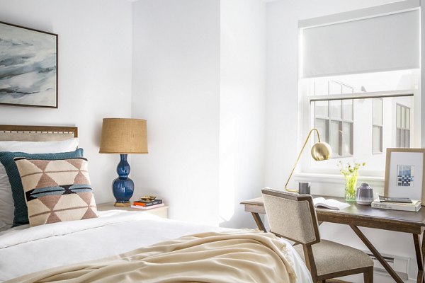 The Madelon Apartments: Elegant bedroom with modern decor and plush bedding